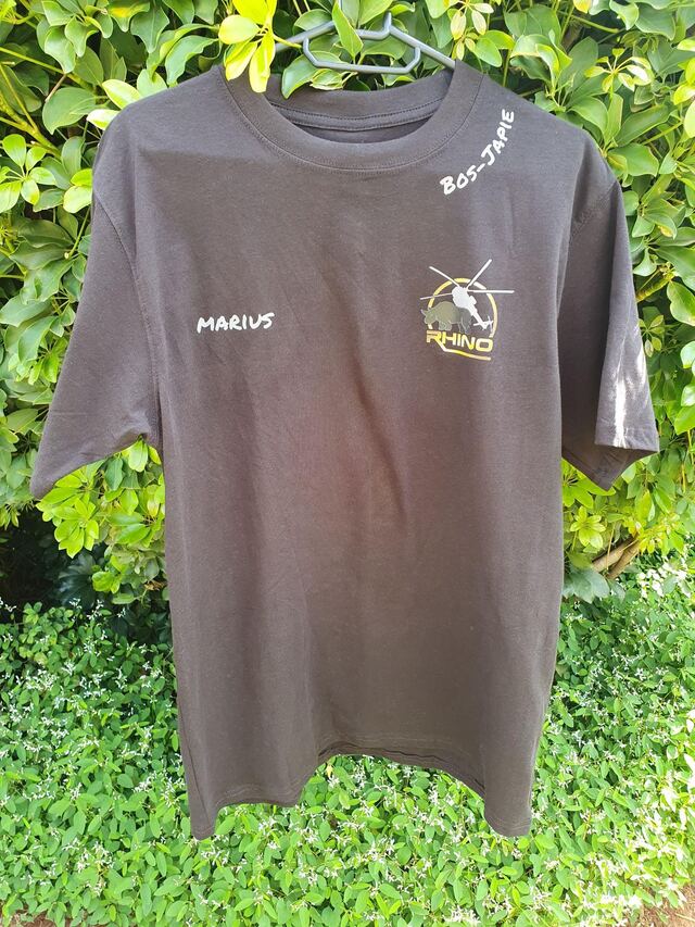 A personalised Rhino Wildvangdienste shirt on a hanger
