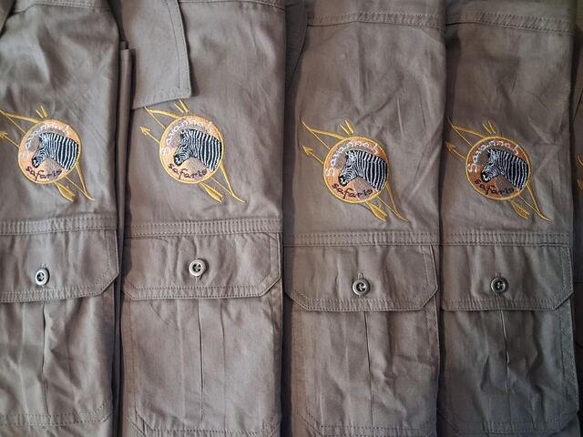 Savannah Safaries bush shirts with an embroidered zebra badge